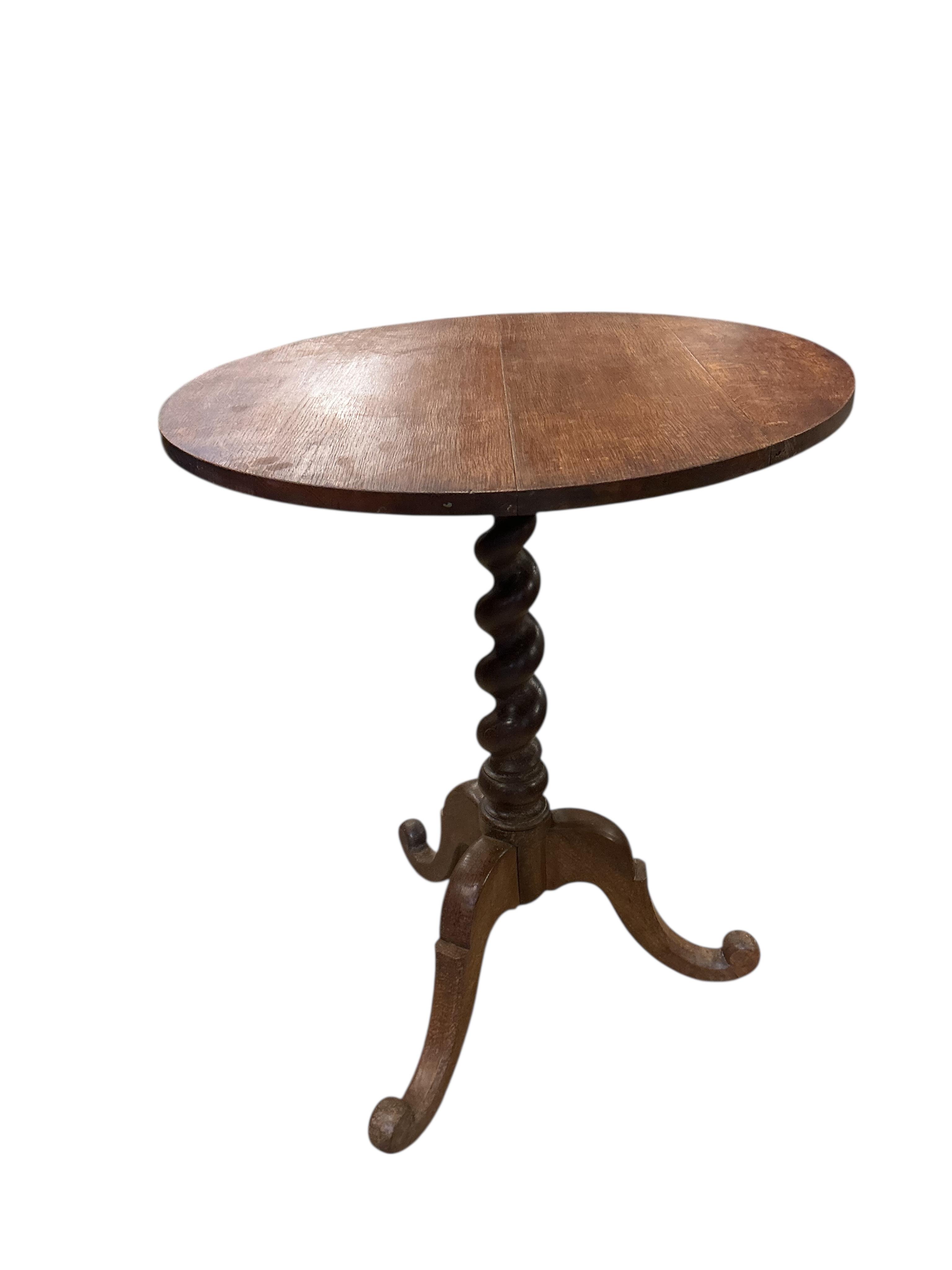 A 19th century circular oak tilt top tripod wine table, diameter 60cm, height 72cm